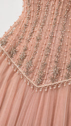 Close-up detail of beaded bodice on pink tulle gown