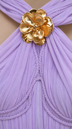 Close-up of gold metallic floral accent on lavender dress