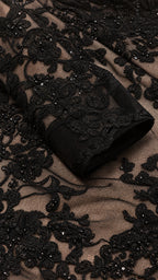 Close-up detail of floral lace and sequin embroidery on sleeve