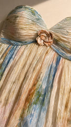Close up of textured pleating and floral applique on strapless dress