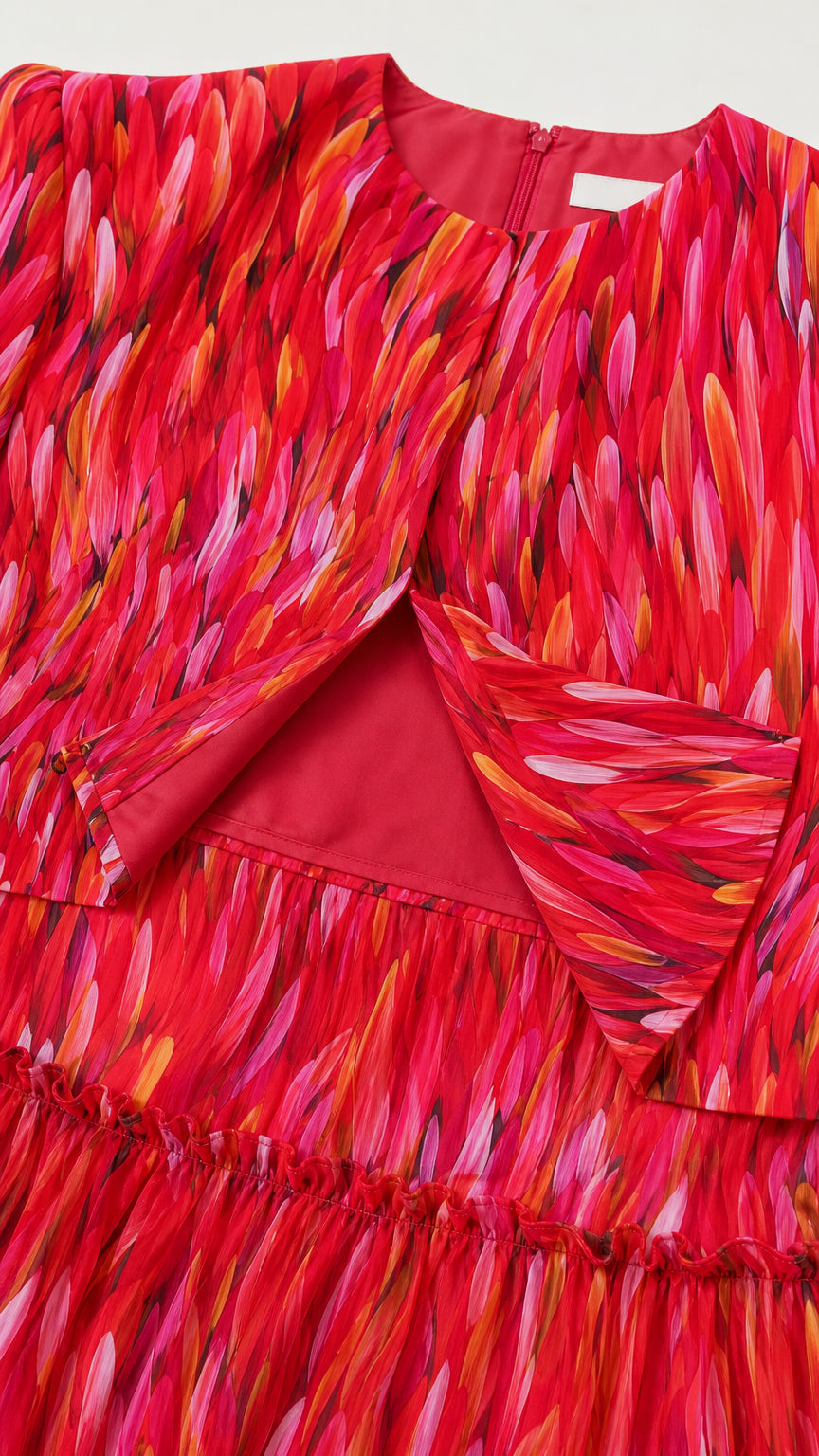 Close-up detail of the red abstract fabric and bodice construction