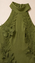 Close-up detail of halter neckline and 3D leaf appliques in olive