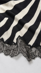 Close-up of the black and white zebra stripe fabric and scalloped lace hem