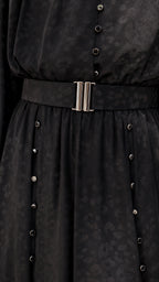 Close-up of black dress belt and button details