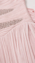 Close-up of crystal embellishment and ruching detail on pink dress