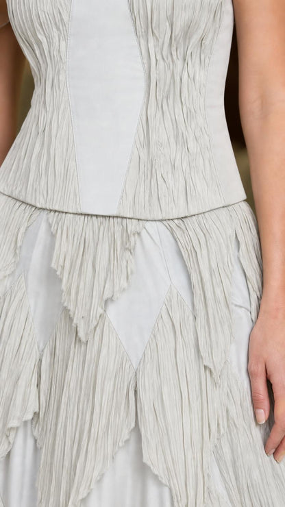 Close-up of bodice and tiered skirt details in light grey