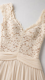 Close-up detail of lace V-neck bodice and pleated waistband