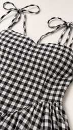 Close-up of fabric texture and tie straps on gingham dress