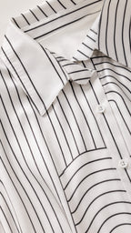 Close-up detail of the shirt collar and geometric pattern fabric