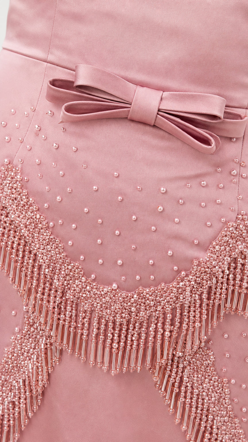 Close-up of beaded fringe and bow detail