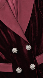 Close-up of contrast lapels and jeweled buttons on burgundy blazer dress
