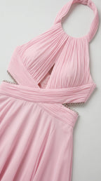 Close-up detail of pink chiffon dress bodice and rhinestone waist trim