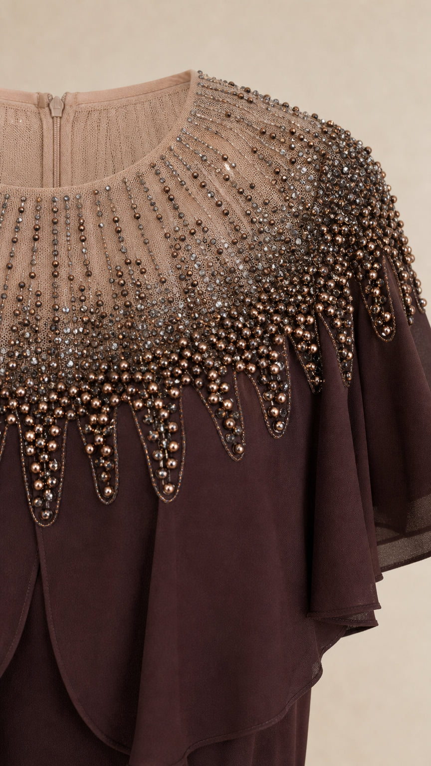 Close-up detail of embellished beaded neckline and capelet