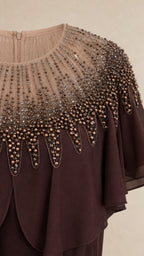 Close-up detail of embellished beaded neckline and capelet