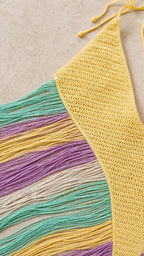 Close-up detail of yellow knit bodice and multicolored fringe