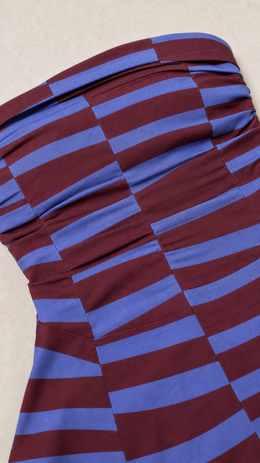 Close-up detail of the striped strapless top construction