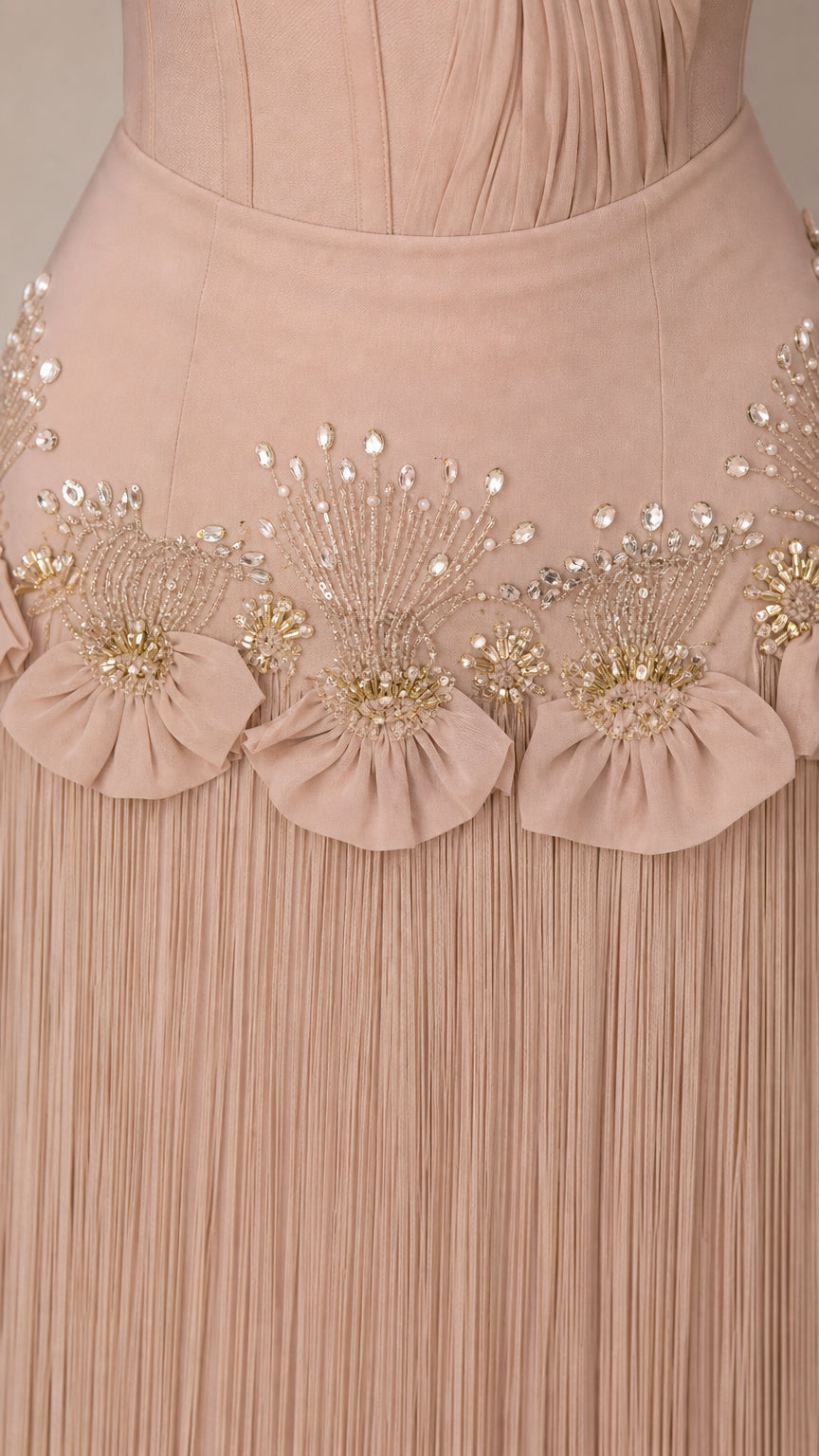Close-up detail of beaded waist and fringe skirt on Champagne gown