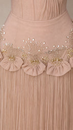 Close-up detail of beaded waist and fringe skirt on Champagne gown