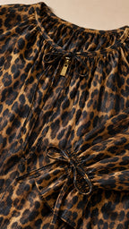 Close up of neckline tie and fabric detail of leopard print dress