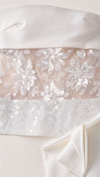 Close up detail of floral sequin embroidery on sheer mesh fabric