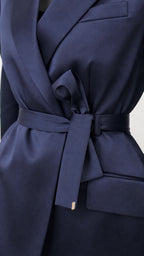 Close-up of navy satin blazer lapel and tie belt detail
