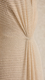Close-up detail of textured fabric and front knot on champagne dress