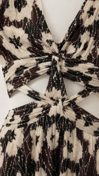 Close-up detail of V-neckline and waist cutout on black floral dress