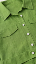 Close-up detail of the green shirt collar and button details