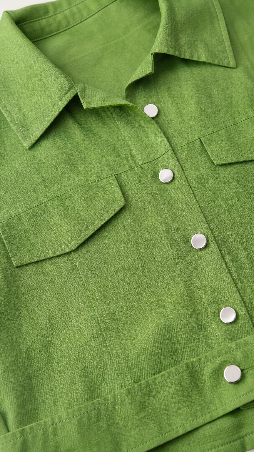 Close-up detail of the green shirt collar and button details