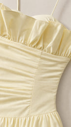 Close-up detail of the ruffled sweetheart bodice and spaghetti strap