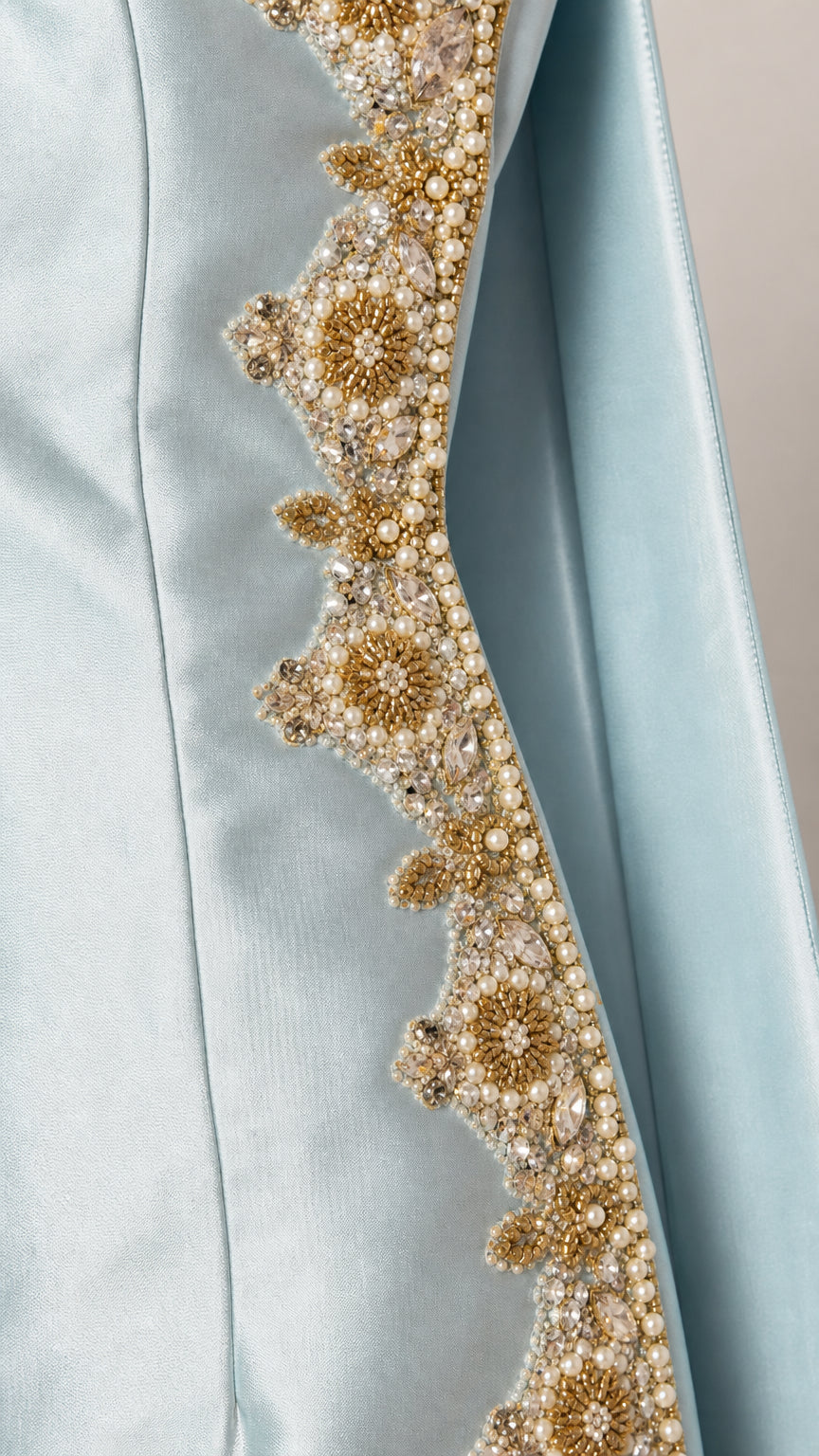 Close-up of gold and pearl embroidery detail on Light Blue fabric