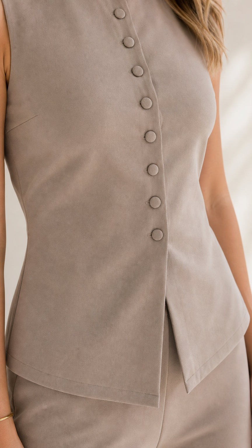 Close up of button details on taupe vest