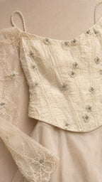 Close-up detail of beaded bodice and sheer sleeves