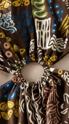 Close-up detail of the waist cutout ring and patterned fabric