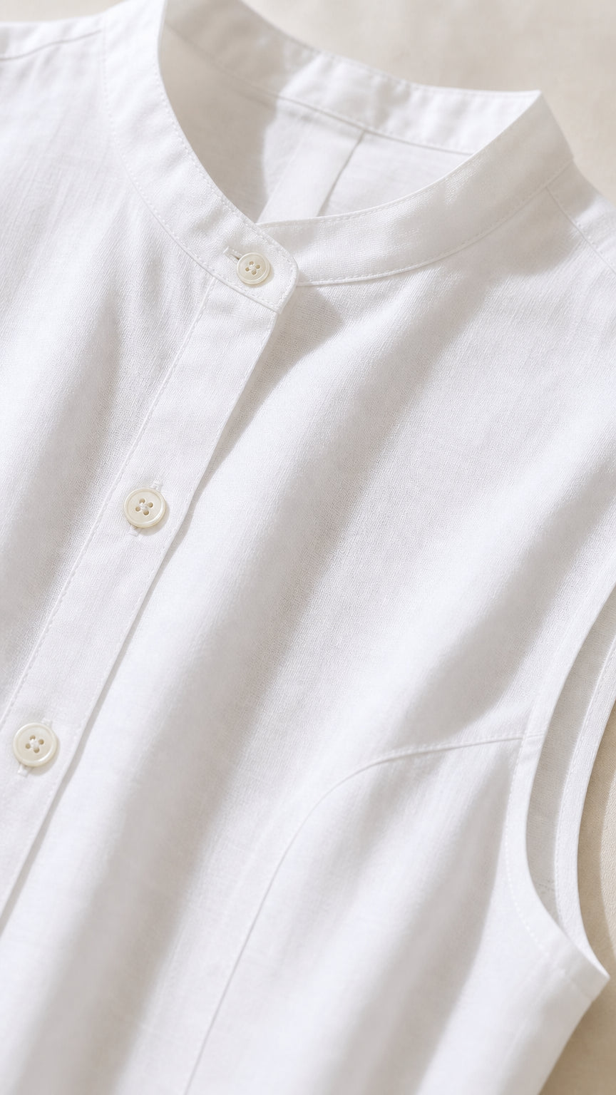 Close-up detail of the stand collar and button placket on the white dress