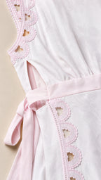 Close-up detail of white dress cutout and scalloped trim