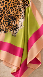 Close-up detail of smooth fabric texture, leopard print, and pink, lime green, and peach stripes