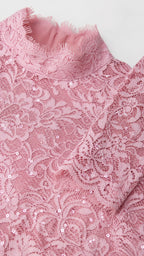 Close-up detail of pink lace texture and neckline