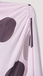 Close-up detail of gathered shoulder and cape fabric