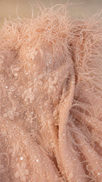 Close-up of feather trim, sequins, and floral lace details