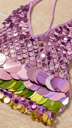 Close-up detail of the pink and multi-colored sequin pattern and halter neckline