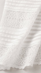 Close-up detail of white lace and striped fabric texture