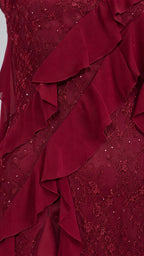 Close-up detail of burgundy lace fabric and cascading ruffles