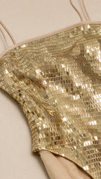 Close-up detail of square gold sequins and strap construction