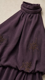 Close-up detail of star beadwork and gathered neckline on Dark Plum dress
