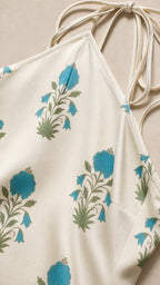 Close-up detail of blue floral pattern on white fabric