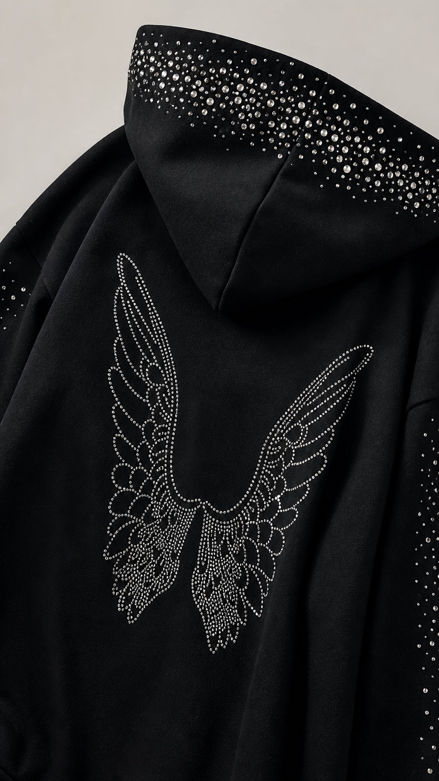 Close-up detail of rhinestone hood trim and back angel wing motif