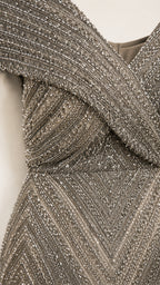 Close-up detail of the crossover V-neckline and beaded pattern