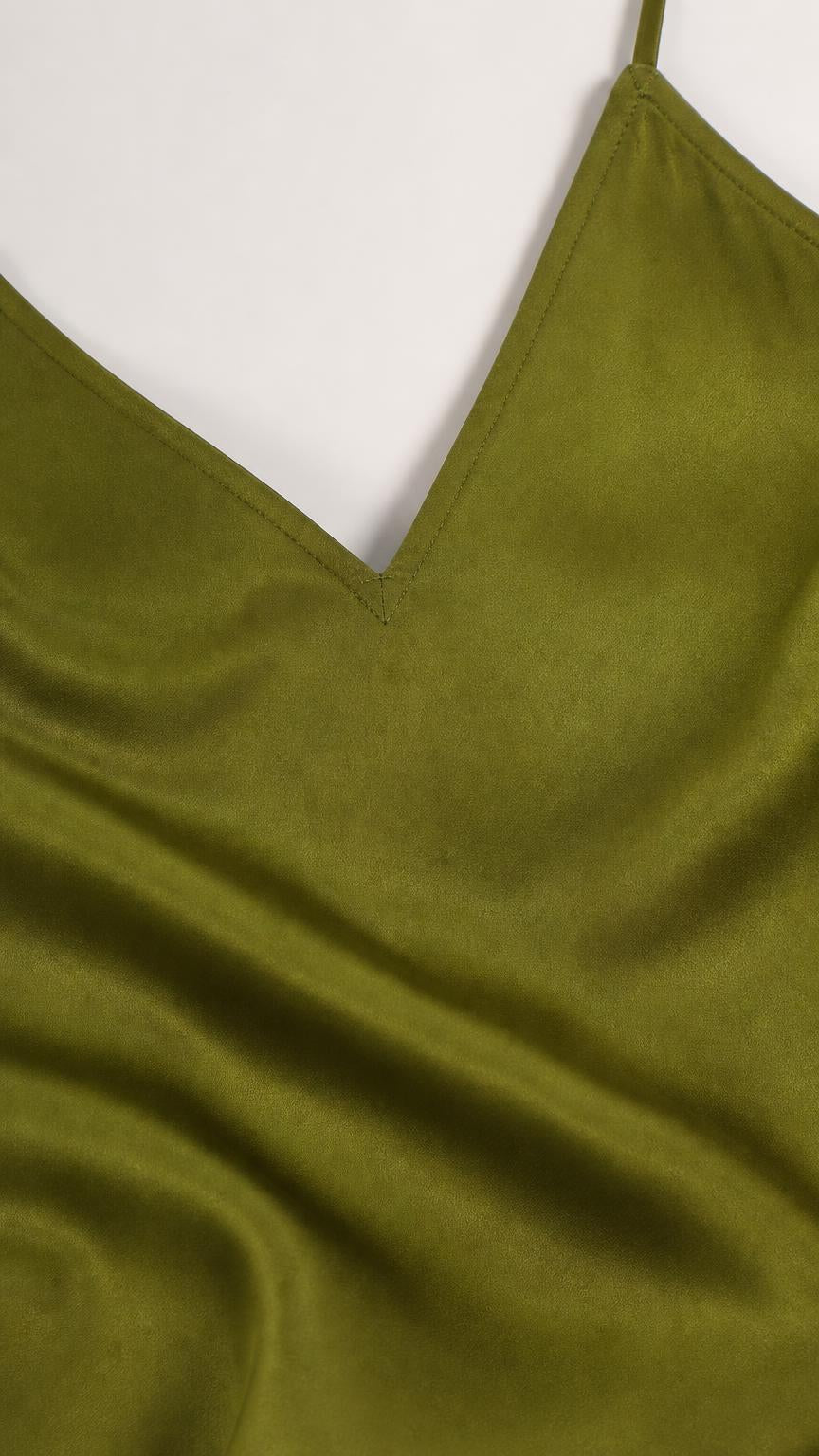 Close up of fabric texture and V-neckline of olive green dress