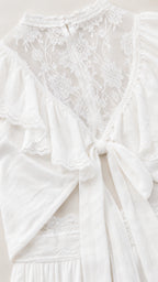 Close-up flat lay of white lace neckline and back tie detail